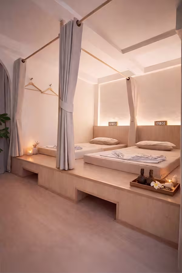 Couples treatment room with two beds and curtains